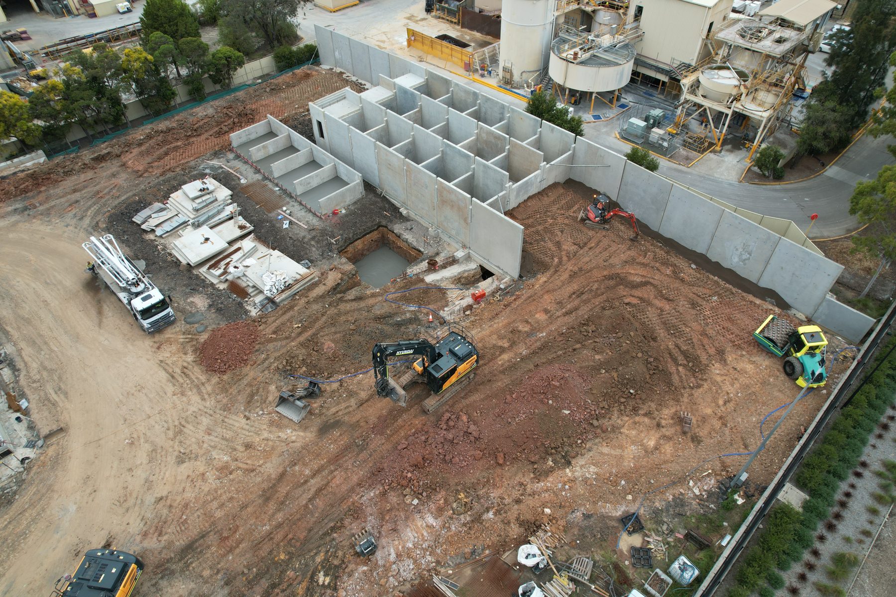 Aerial view of a plant site with bin walls and excavators